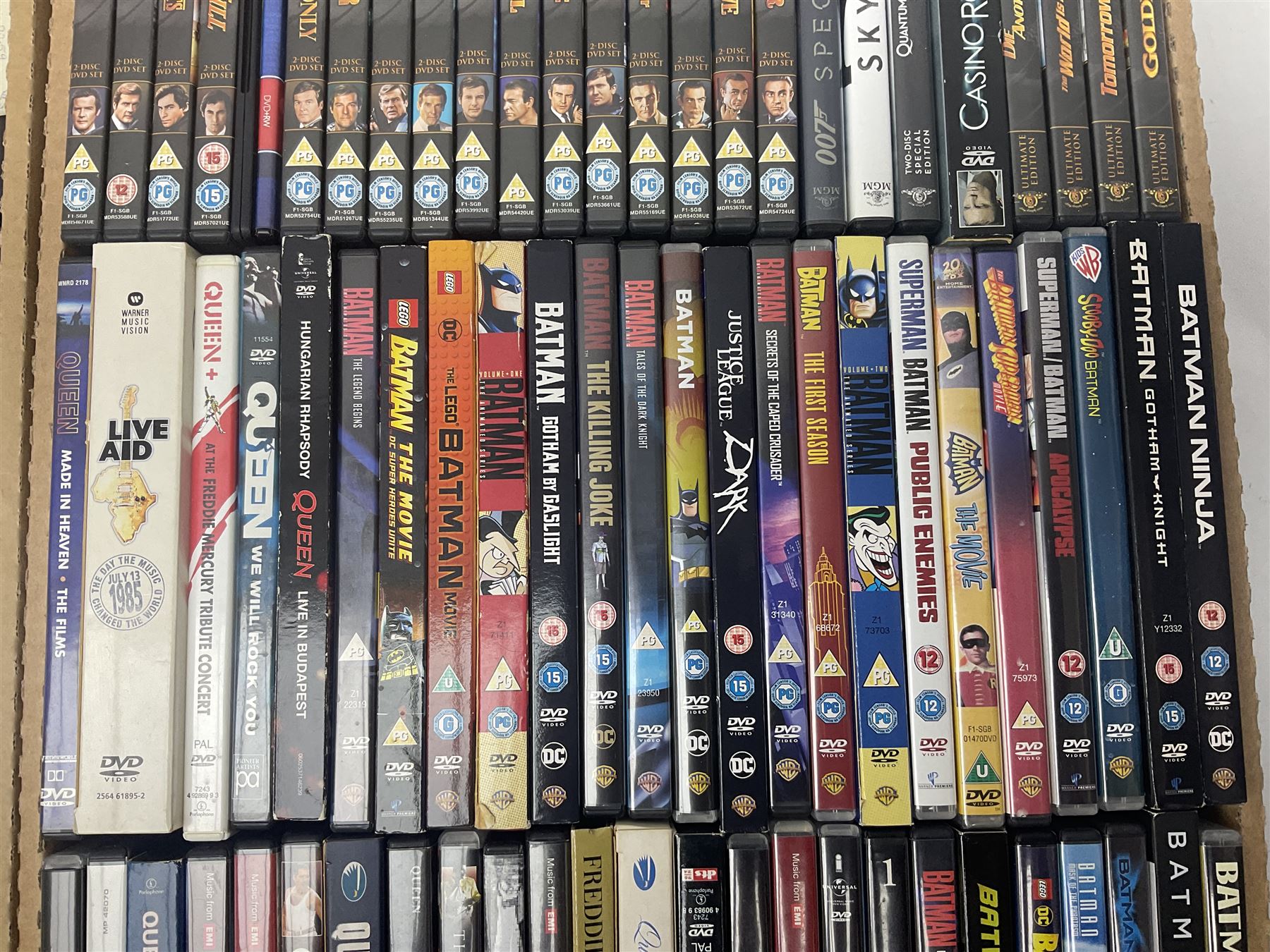Large collection of VHS tapes, DVDS, CDs to include Queen, James Bond 007, Batman etc, in three boxes