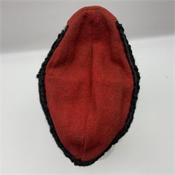 WW2 German small size Balkan style hat with 'SS' metal badges; red cloth top and flash to front with black persianelle type sides; lined in brown card with leather sweatband