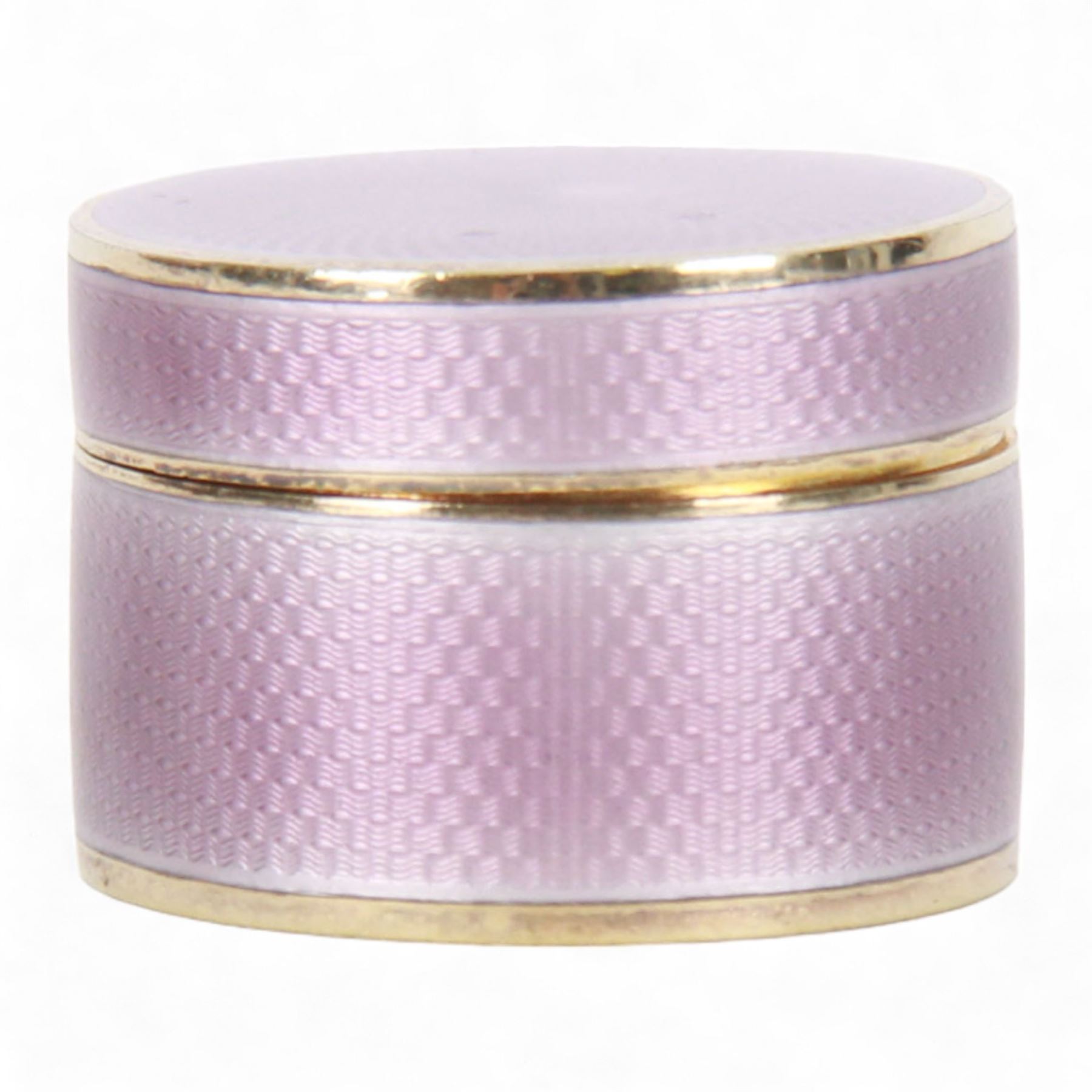 Small early 20th century silver gilt and lilac guilloche enamel box, of cylindrical form, the cover lifting to reveal a gilt interior, hallmarked Asprey & Co Ltd, London 1910, H2.5cm D4cm