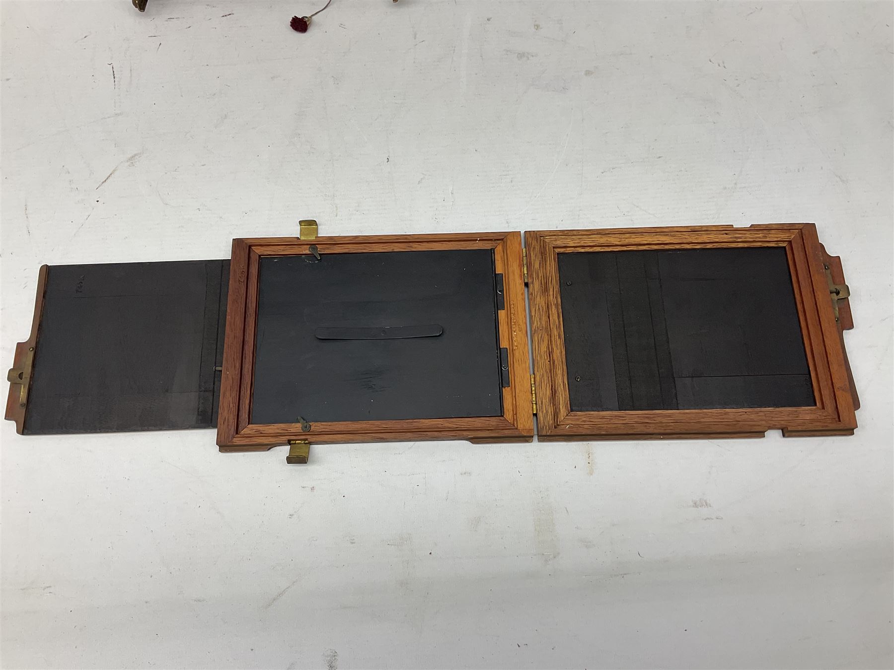Thornton Pickard Imperial Triple folding plate camera in mahogany and lacquered brass, field model, three mahogany photographic plates and a wooden tripod