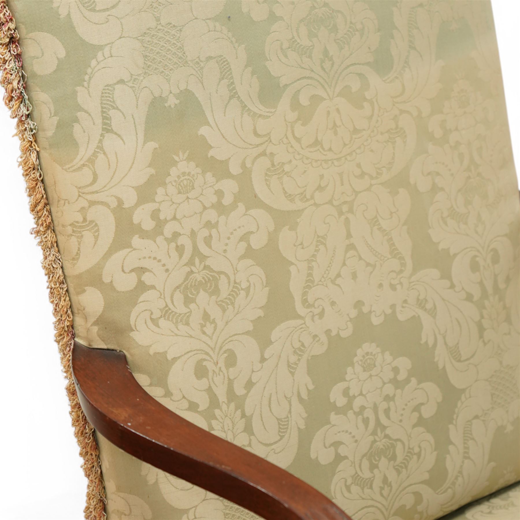 Georgian design mahogany framed Gainsborough armchair, arched cresting rail over shaped arms on curved and moulded supports, upholstered in pale green fabric with repeating foliate pattern, on square tapering moulded supports united by plain stretchers 