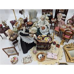 Dolls house living room and ding room furniture, including sofa, chair, long case clock, Christmas trees, fireplace, dresser, chairs, tables, mirrors, seven figures and a collection of predominantly Christmas themed decorations, food, etc