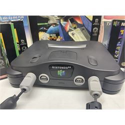 Nintendo 64 console, two controllers, games and accessories. Accessories to include the ‘Tremorpak’ and ‘Spook’ 2 Phono plugs and a S-VHS plug with adapter, both in original boxes. Games to include ‘Golden Eye 007’, ‘Doom 64’, ‘Killer Instinct Gold’, ‘Tetrisphere’, ‘F-1 World Grand Prix’, ‘Pilotwings 64’ and ‘Lylatwars’ with ‘Rumble Pak’, all with original boxes and instruction manuals. ‘Star Wars Episode I Racer’ game cartridge in Shadows of the Empire box. 
