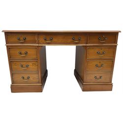 Cherrywood twin pedestal desk, rectangular leather inset top over central fall front with keyboard slide and two drawers, fitted with two drawers and cupboard, on bracket feet