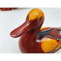 Collection of Poole Pottery, comprising charger and vase in Volcano pattern and a duck figure in a similar pattern 