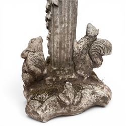 Pair of weathered composite stone garden figures, modelled as a girl and a young satyr playing the panpipes seated on column supports, the fluted columns with climbing ivy vines and surmounted animal, butterfly and other zoomorphic motifs