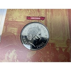 The Royal Mint United Kingdom 1984 brilliant uncirculated coin collection, 1997 and 2001 commemorative crown coins, 1997 old round one pound, all in card folders and four sterling silver medallic first day covers from the 'Great Britons' collection housed in a blue folder