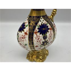 Pair of mid 20th century Royal Crown Derby Imari 1128 pattern Kedleston ewers, each with gilt scroll handle and neck, upon a gilt quatrefoil foot, each with printed marks beneath, H25.5cm
