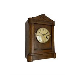 German striking mantle clock in an oak case by the Hamburg and American Clock company, with an 8-day spring driven movement, striking the hours on a coiled gong.