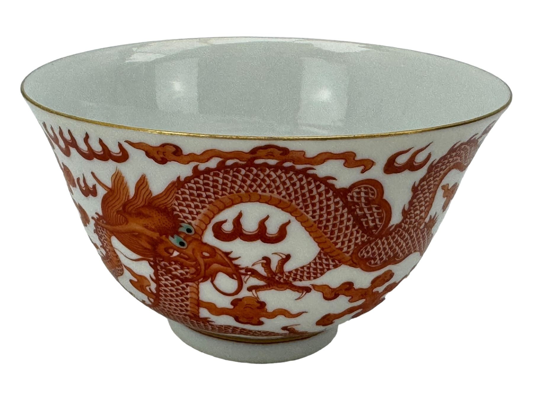 Chinese porcelain iron red tea bowl, the exterior painted with two five claw dragons chasing the flaming pearl, amidst clouds, red Quinlong seal mark beneath, D10.5cm x H6.5cm