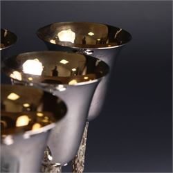 Eight silver goblets, comprising set of six, each plain fluted bowl with gilt interior, upon bark effect stem and domed circular foot, and a pair of very similar examples boxed with large hallmarks to bowls, hallmarked Pinder Brothers, Sheffield 1970 and Sheffield 1976, H14cm