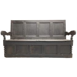 18th century oak box seat settle bench, pegged construction with quadruple panelled back over double hinged box seat, shaped projecting arms with scroll carved terminal detail, on block and bobbin turned front supports, panelled front within moulded frame