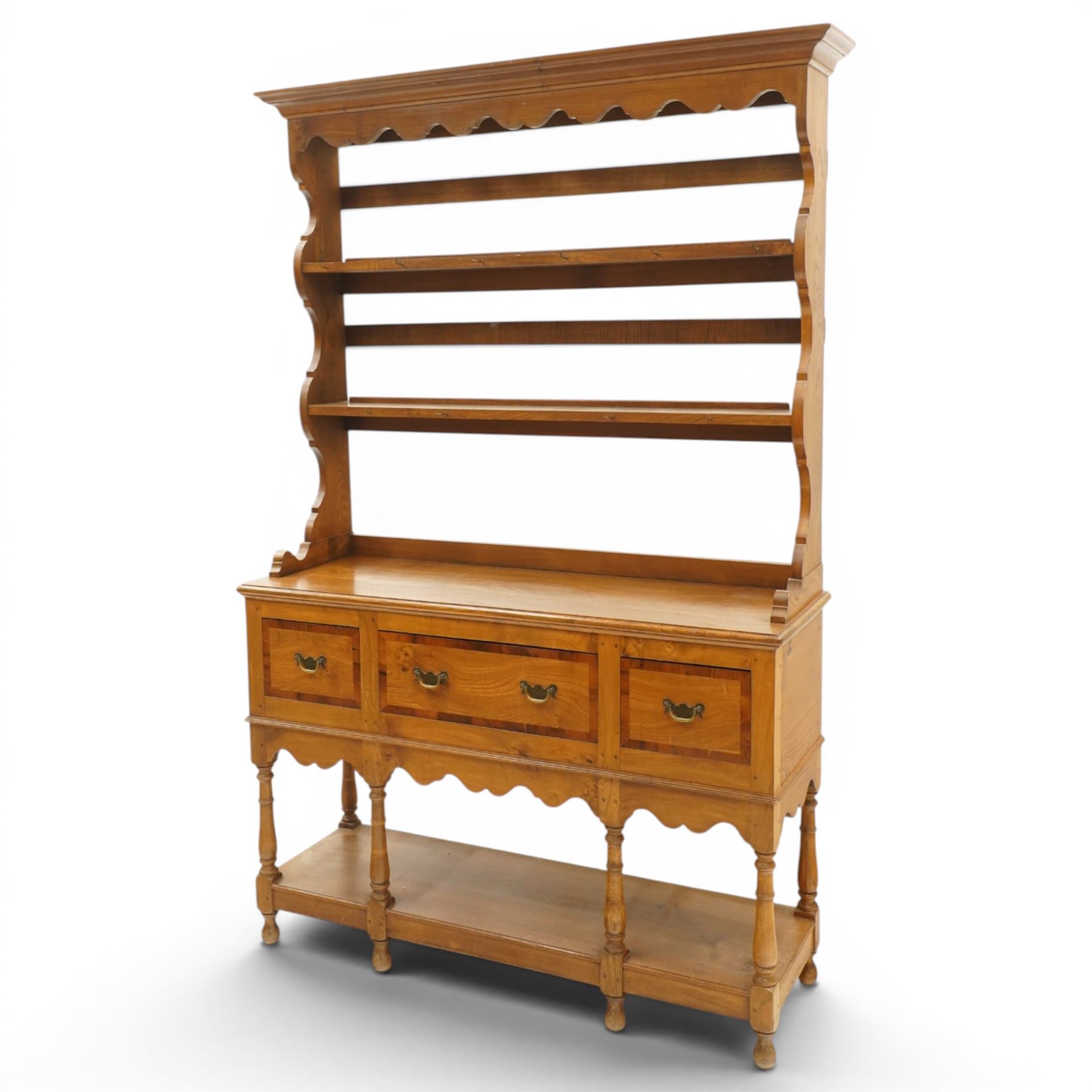 Georgian design elm dresser with plate rack, the two-tier rack with shaped frieze and hooks, over a rectangular top, fitted with three yew-wood banded drawers, shaped apron over turned supports united by undertier