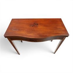 Regency period inlaid mahogany serpentine-fronted fold-over tea table, the shaped rectangular top with ebony-strung edge over a banded frieze with repeating lozenge inlaid banding, on square tapering supports