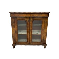 Victorian walnut display cabinet, fitted with two glazed doors