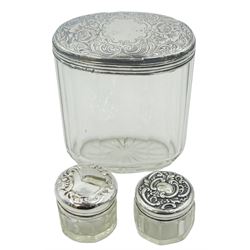 Group of silver mounted cut glass dressing table jars and bottles, of various size and form, to include one example of cylindrical form with plain cover hallmarked Barclay Brothers, Birmingham 1921, other examples with various hallmarks, dates ranging 1881 to 1935, approximate total weighable silver 2.12 ozt (66 grams)