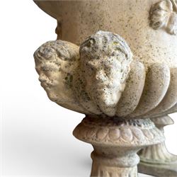 Pair of large cast stone garden urns, circular form with egg and dart border, tapering gadrooned bowl with cast handles and detail