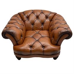 Tetrad - 'Oskar' armchair, Chesterfield shape with rolled arms, upholstered in buttoned tan leather, on turned and reed moulded feet 