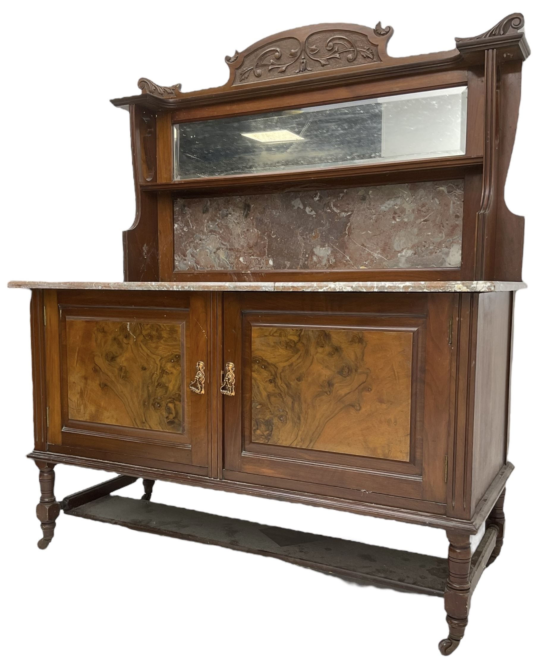 Late Victorian walnut washstand, raised back with carved pediment over bevelled mirror and marble panels, rectangular marble top, fitted with two figured panel doors, on turned supports