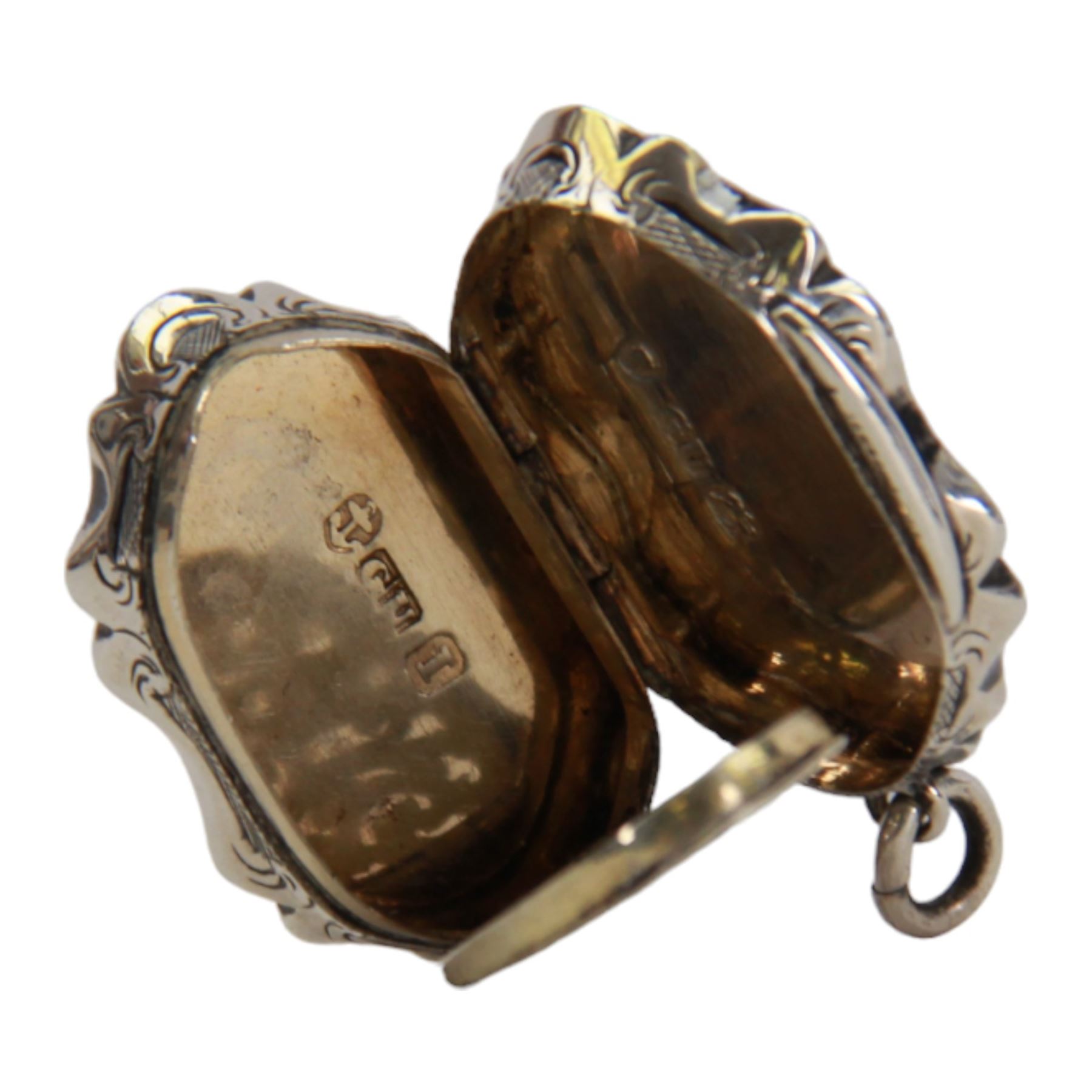 Victorian silver vinaigrette, of oval form with shaped edge, decorated throughout with engine turned bands, the hinged cover with vacant C scroll panel opening to reveal a foliate pierced grille and gilt interior, hallmarked George Unite, Birmingham 1857, L3.5cm