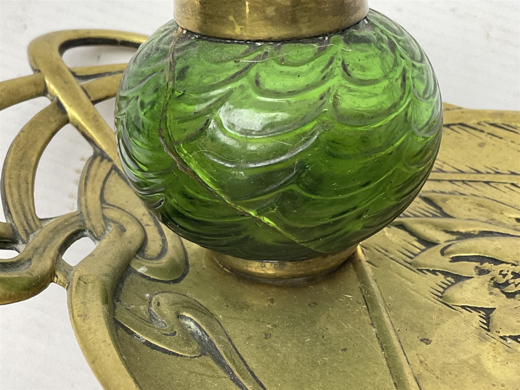 Art Nouveau Geschutzt brass desk stand, with stylised whiplash relief decoration, with removable Loetz style green glass inkwell, stamped to the base, H8cm