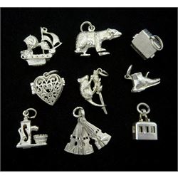 Nine silver charms including a dog in a kennel, polar bear, cable car, pirate ship, heart with openwork decoration, etc. 