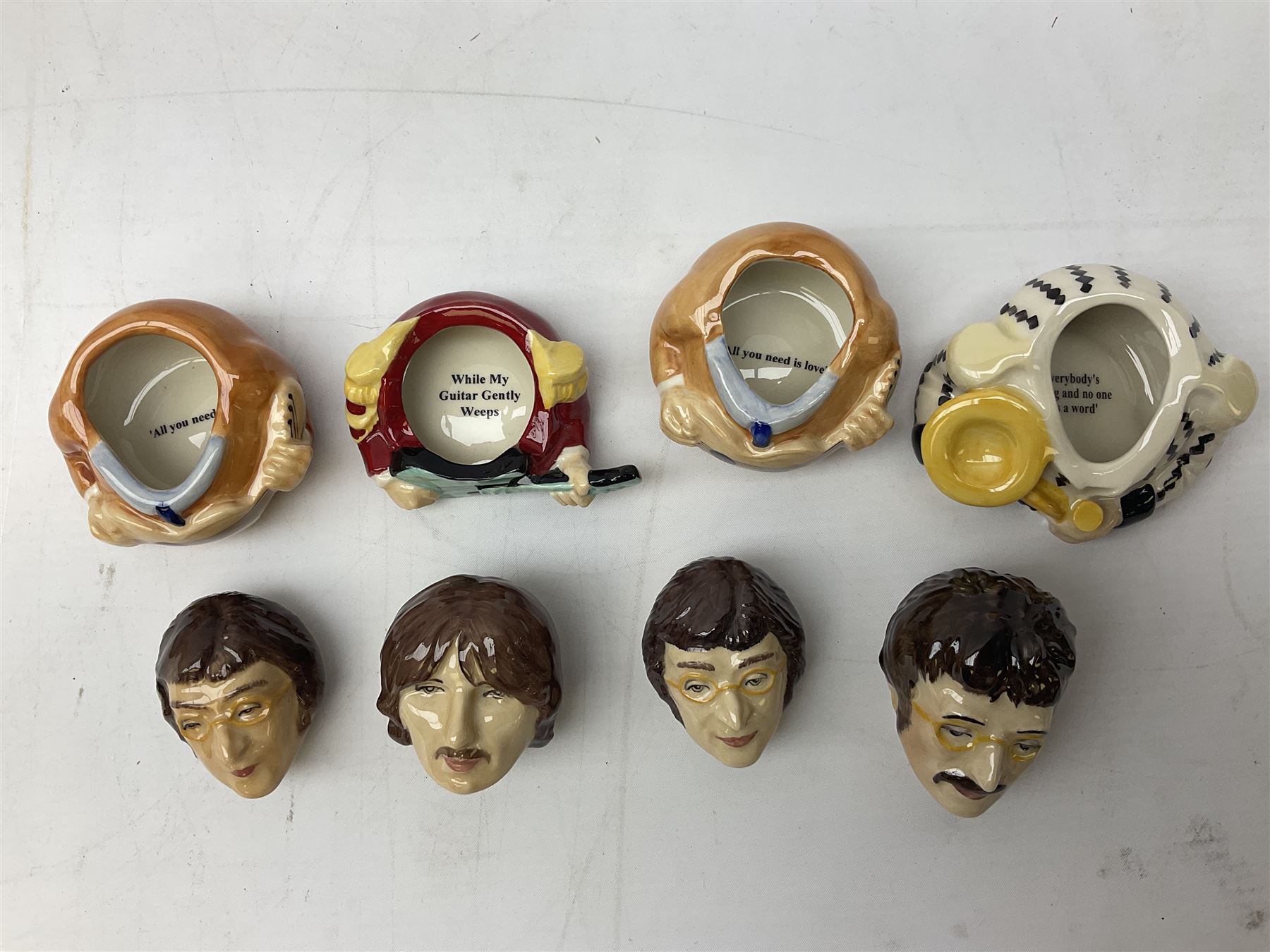 Fifteen Face Pots by Kevin Frances, all of music interest, to include the Beatles; Paul 'Kookoocachu', 'Love Is All You Need', 'Octopus's garden', 'While My Guitar Gently Weeps', 'All You Need Is Love' and 'Everybody's talking and no one says a word', Elton John; I'm still standing, Buddy Holly; 'That will be the day', David Bowie 'We can be heroes' , Mick Jagger prototype colour type etc, all boxed  