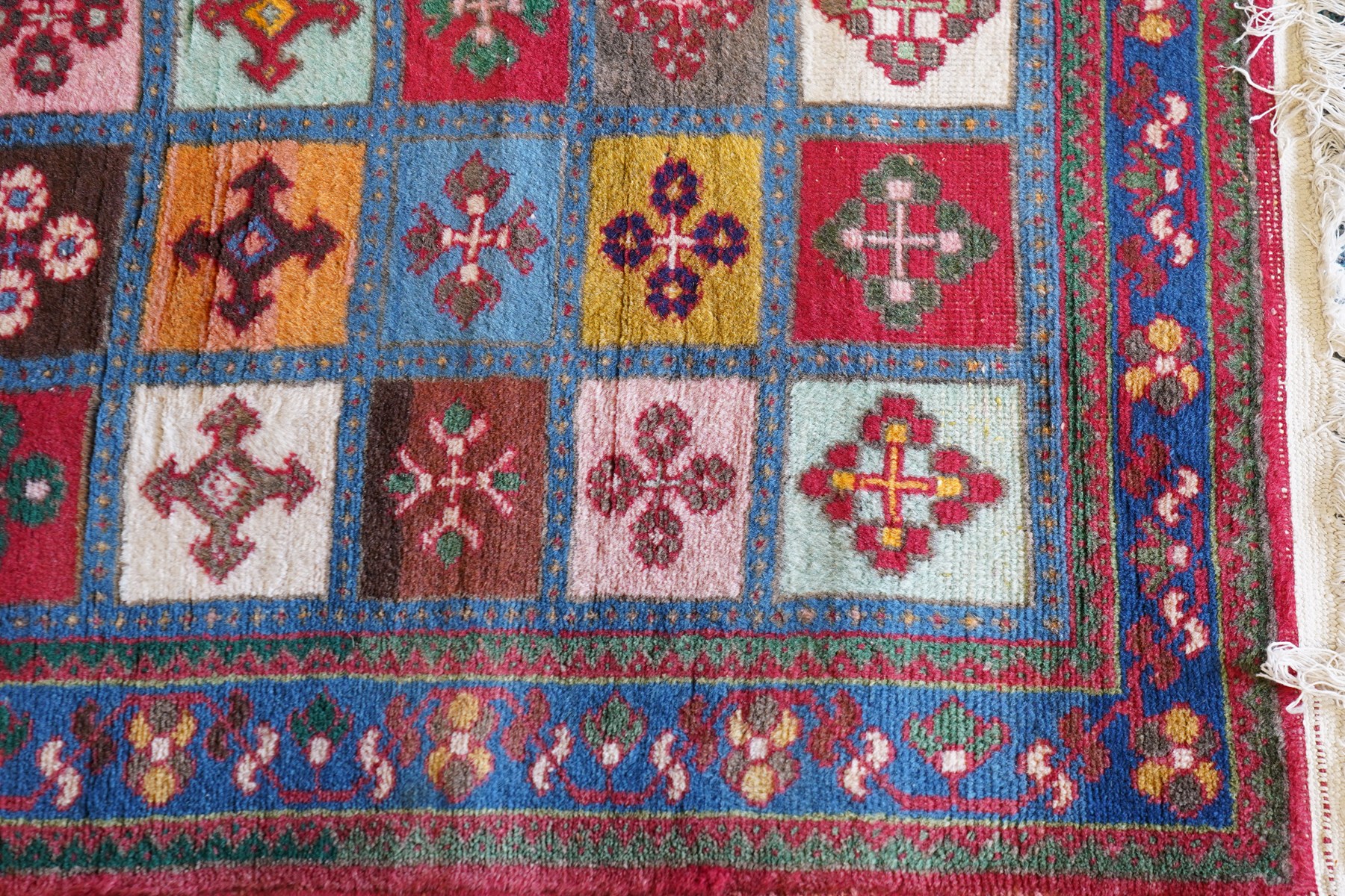 Persian Gabbeh indigo ground runner rug of garden design, the multi-coloured field decorated with five columns of panels in contrasting colours with stylised plant motifs, the guard band with trailing foliage