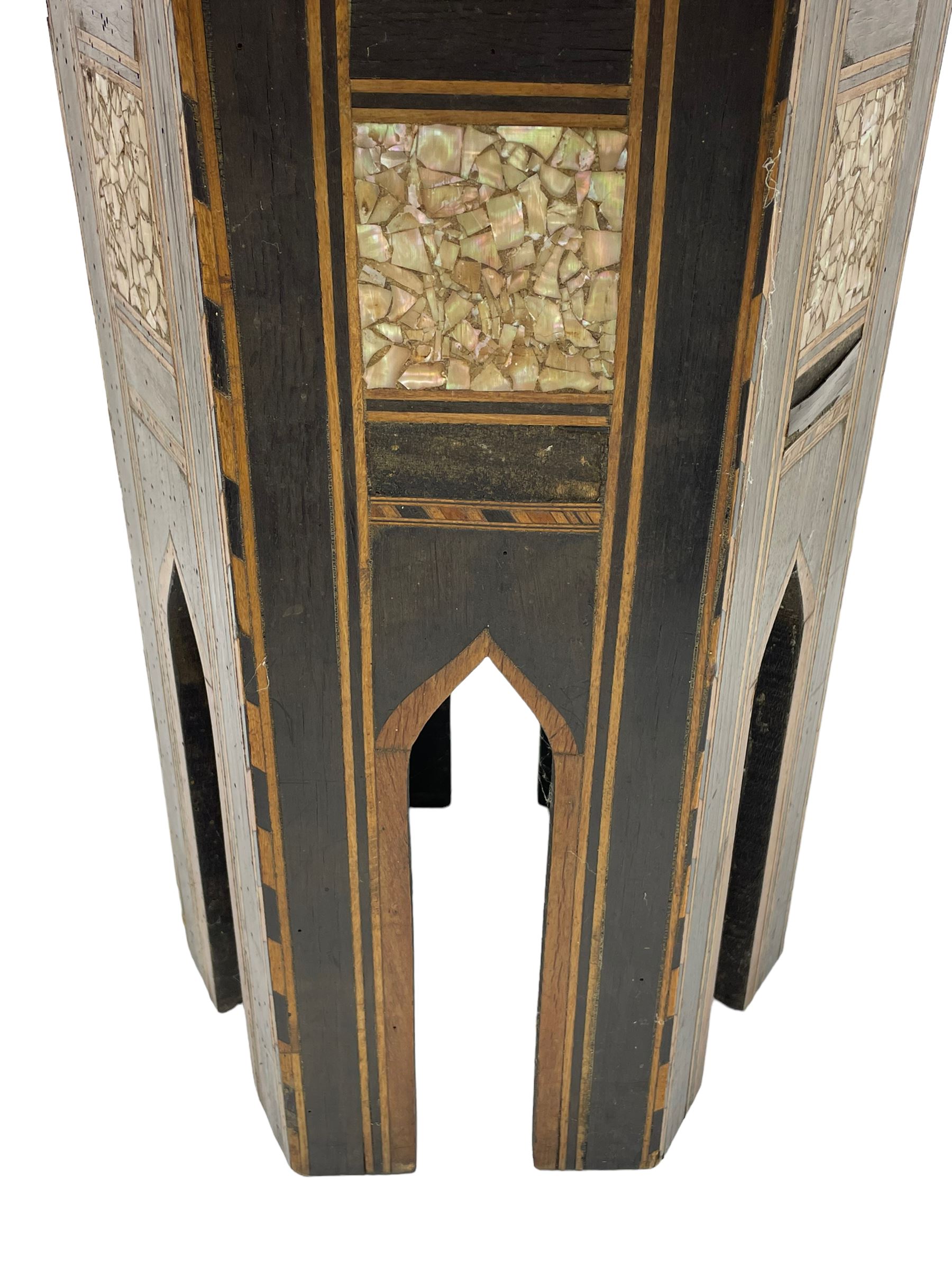 Early 20th century Anglo-Indian hexagonal table, the top decorated with mother of pearl beads and chequered banding, the base with fretwork pointed arches and inlays