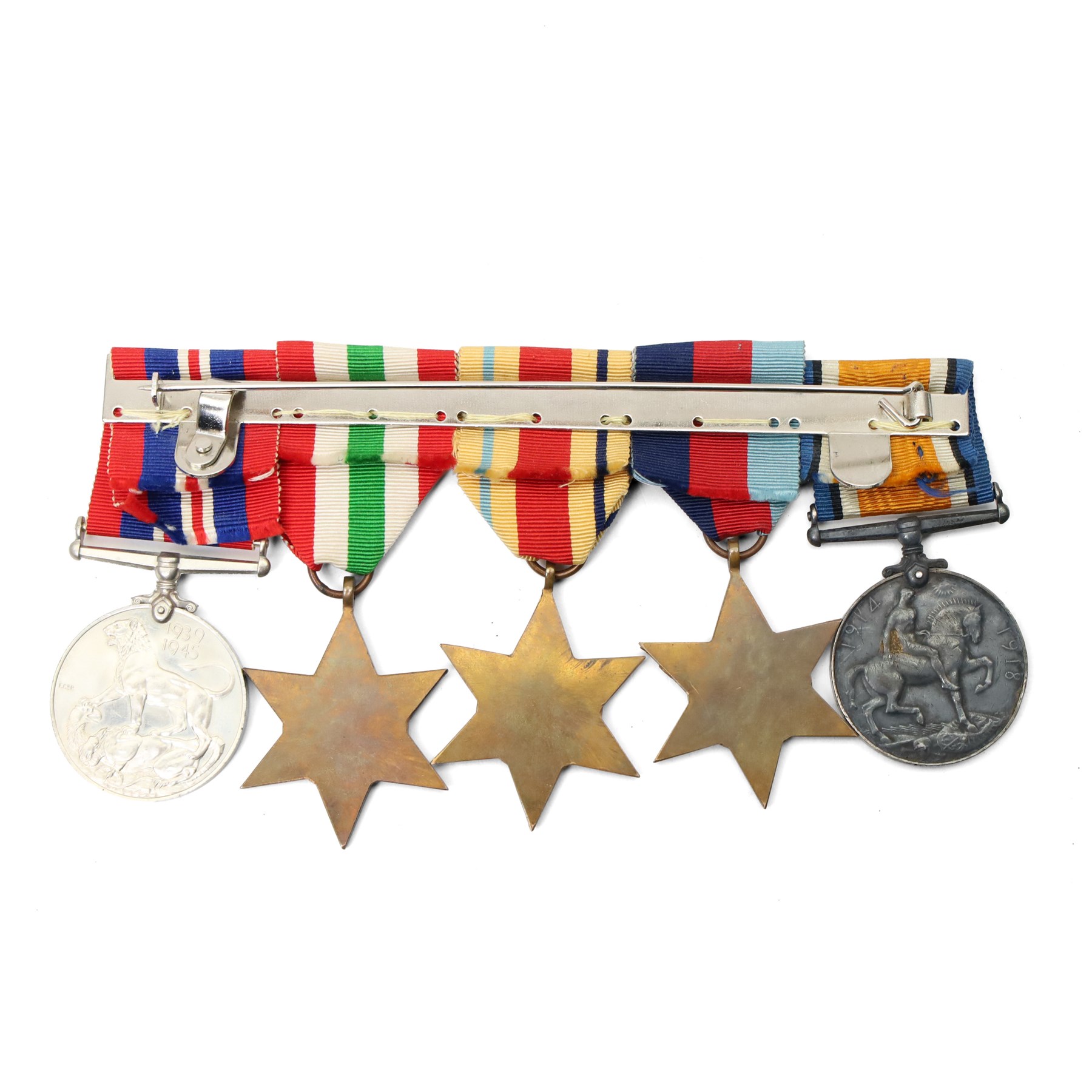 Five medals, possibly a family group comprising WWI War Medal to 9220 Pte H L Skillicorn, Machine Gun Corps and four WWII medals comprising War Medal, Africa Star with 8th Army bar, 1939-1945 Star and Italy Star, a German cap badge and one other German badge