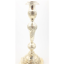  Pair of silver Sabbath candlesticks with leaf and scroll decoration on on scalloped weighted bases by Moshe Rubin London 1926, H.26.5cm   