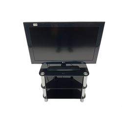 LG television on black glass stand