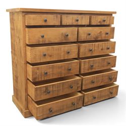 Indigo Furniture - large rustic oak combination chest, three drawers above ten drawers, with blackened pulls, raised on a plinth base