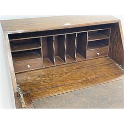 Early 20th century oak bureau, single fall front enclosing fitted interior above three graduating drawers, turned supports 