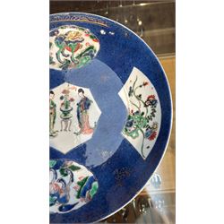 Chinese powder blue ground famille verte charger, possibly Kangxi, decorated with a central cartouche enclosing two female figures, with smaller shaped panels enclosing lions and foliage, square seal mark in blue to base, D28cm