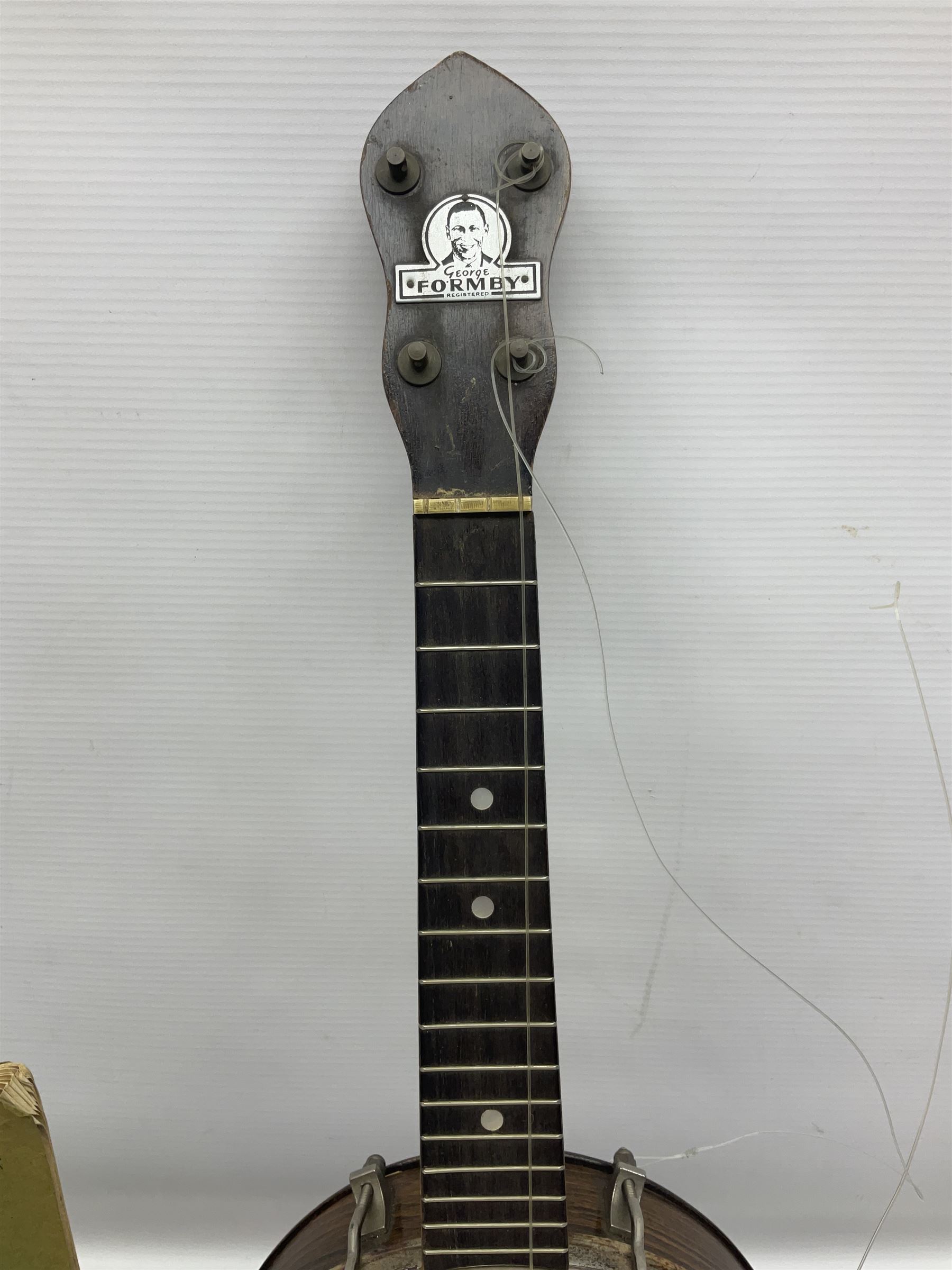 George Formby banjolele with metal plaque to headstock L55cm; in carrying case with instruction booklet.