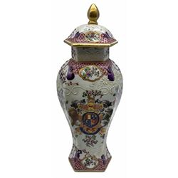 Late 19th century Samson Armorial vase and cover,  of faceted baluster form, decorated in the Compagnie des Indes style with armorial crest and floral sprays, with spurious character mark beneath, H28.5cm