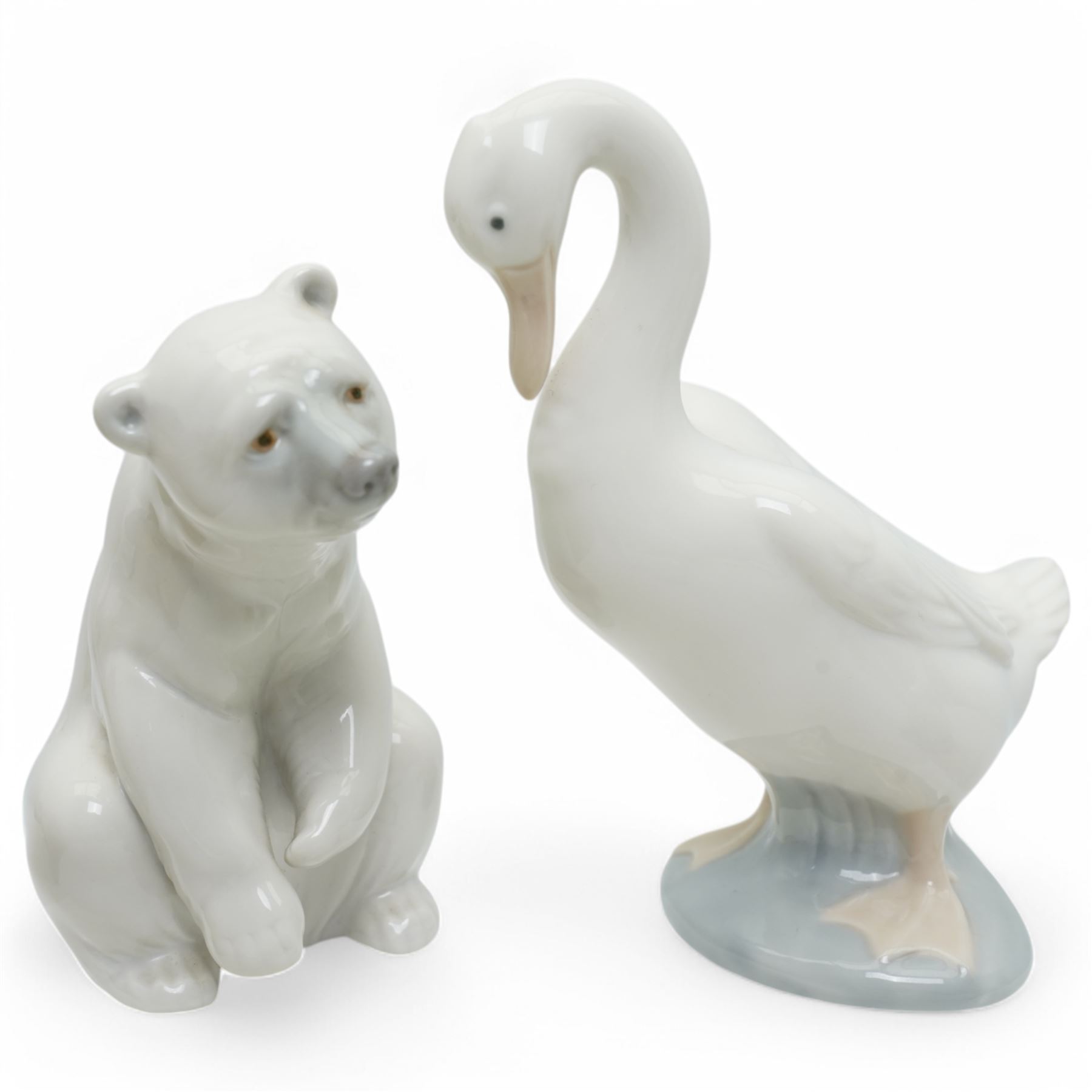A group of eight Nao figures, together with one Lladro Polar Bear figure, each with printed mark beneath (9)