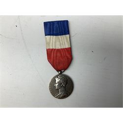Five continental medals - WW1 Belgian Cross of Fire; WW1 French Croix De Guerre; French Croix De Combattant; French Republic Workers silver merit awarded to L. Mounet 1950; and boxed French Palmes Universitaires Officier d'Academie silver and enamel wreath (5)