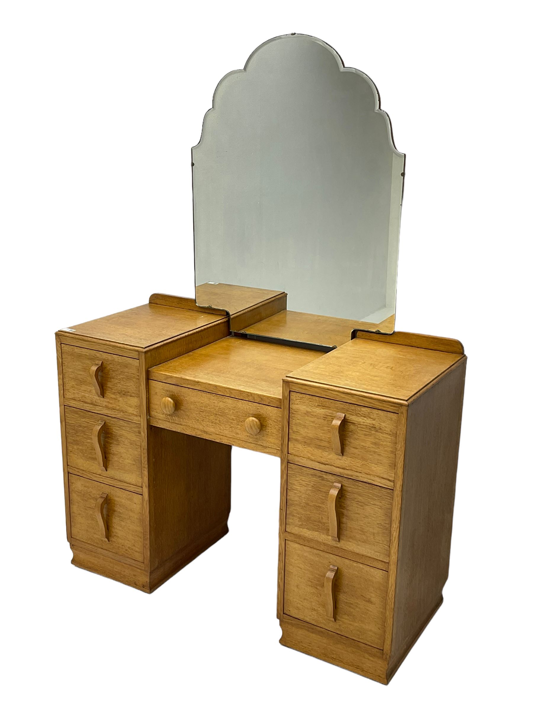 Mid20th century light oak twin pedestal dressing table, shaped mirror