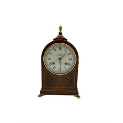 Comitti of London - 20th century 8-day mantle clock, in classic round topped mahogany case with inlaid stringing to the front and lion mask handles to the sides, raised on a narrow plinth with bracket feet, twin train going barrel movement with a floating balance escapement, striking the hours and half hours on a bell.    