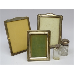  Three silver fronted picture easel frames arched top and oak mount by, Sanders & Mackenzie H22cm, rectangular form by E Mander & Son, 1918 and a shaped and embossed frame with oak mount, Edwardian cut glass dressing table jar with silver top and scent bottle   