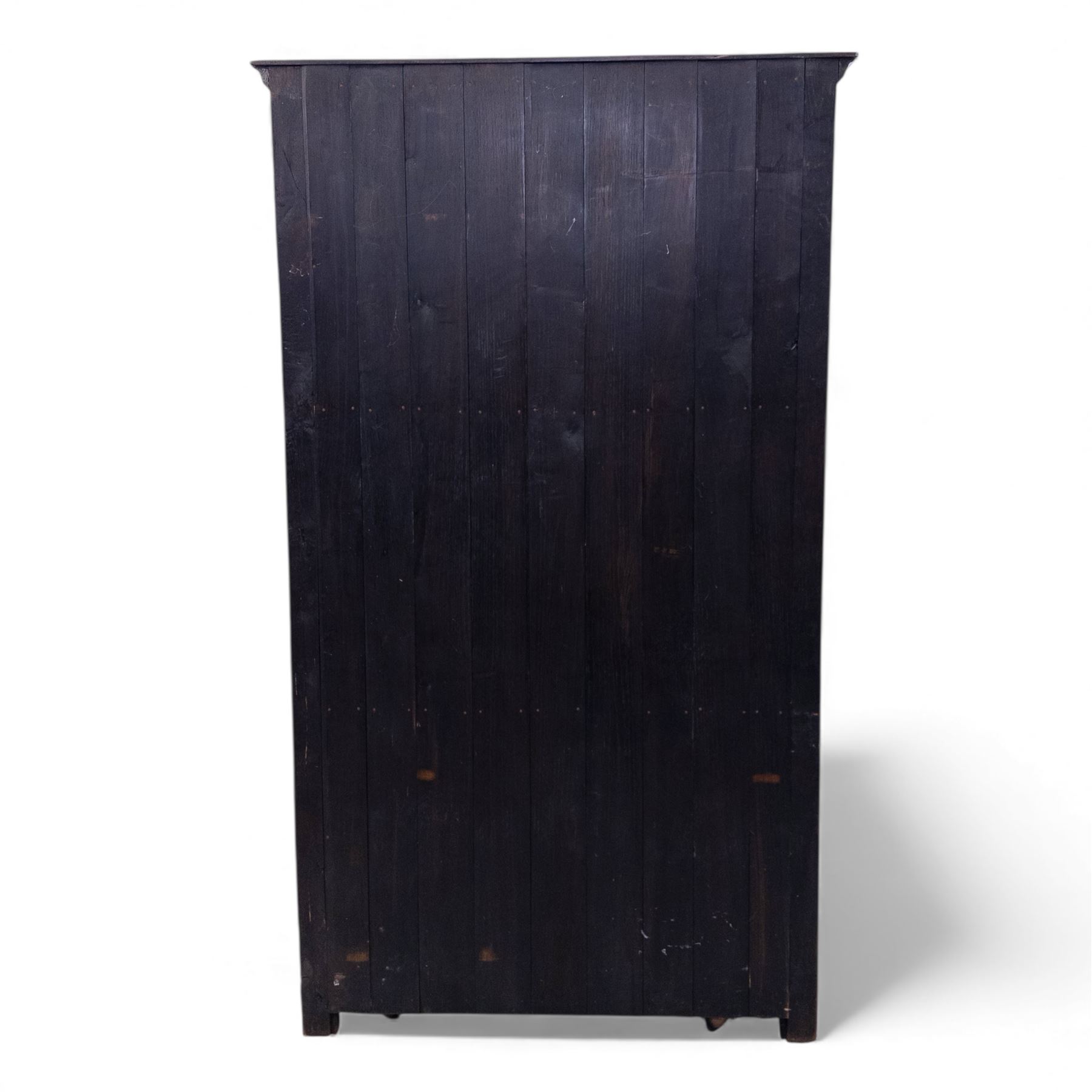 Mid 20th century oak double wardrobe, the rectangular top above twin panelled doors with carved linenfold decoration and wrought iron hinges, raised on block feet
