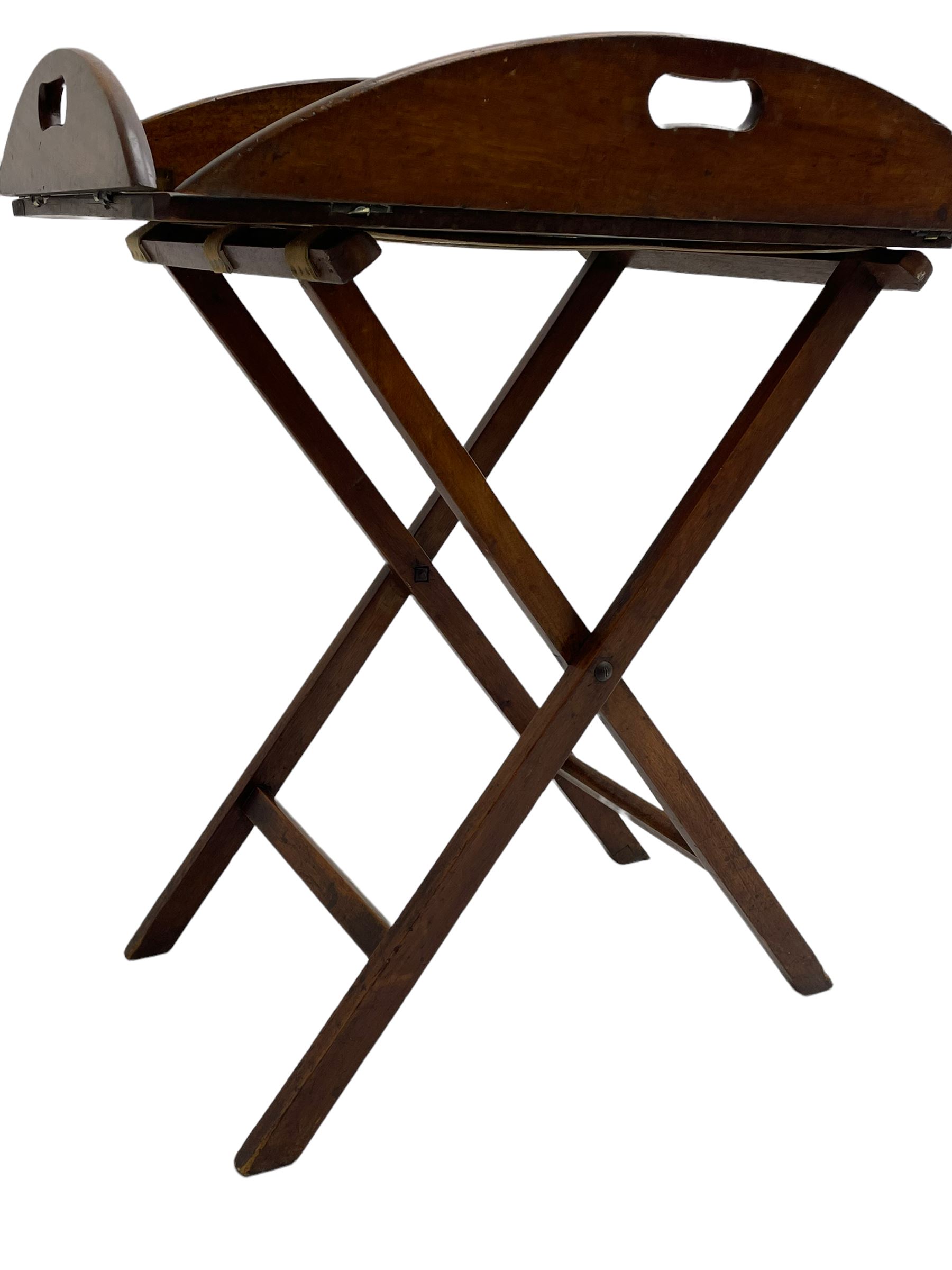 George III mahogany butler's tray on stand, the panelled tray with hinged sides pierced with handles, on folding stand
