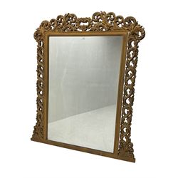 Large ornate gilt framed mirror, the pediment with central cartouche with extending pierced and moulded scroll work and acanthus leaves