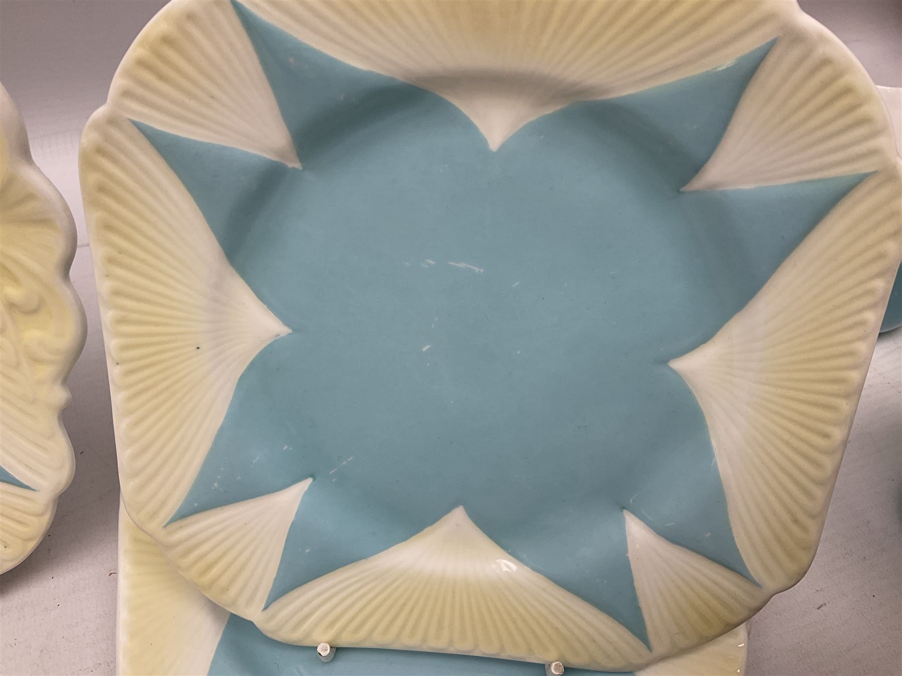 Shelley Dainty pattern tea wares, of lobed form with blue star decoration on merging white and yellow ground, comprising five teacups, five saucers, six tea plates, milk jug and cake plate, all with printed green mark beneath, some with painted pattern no 11770