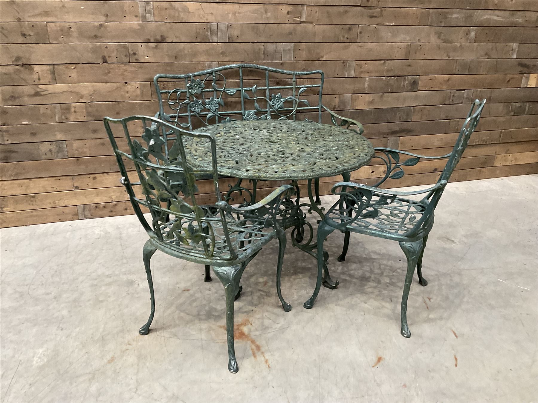 Cast aluminium garden dining set, comprising ornate circular table (D91cm, H68cm) a two seater bench, on cabriole supports (W118cm, H93cm, D55cm), and two matching armchairs (W55cm, H95cm, D54cm)