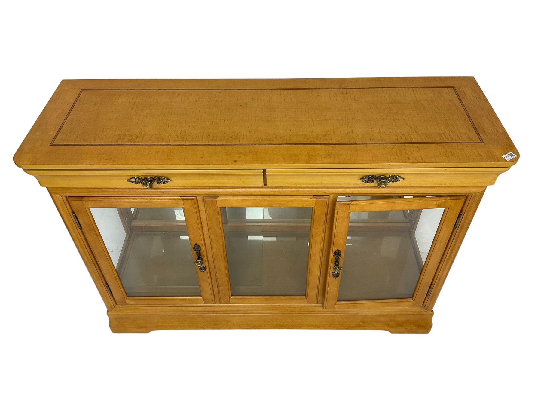 Yew wood sideboard, rectangular top with mahogany and ebony stringing, fitted with two drawers over three glazed cupboard doors enclosing glass shelves