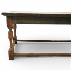 Late 17th to early 18th century oak joint refectory dining table, rectangular four plank top, raised on turned baluster legs, united by chamfered stretchers