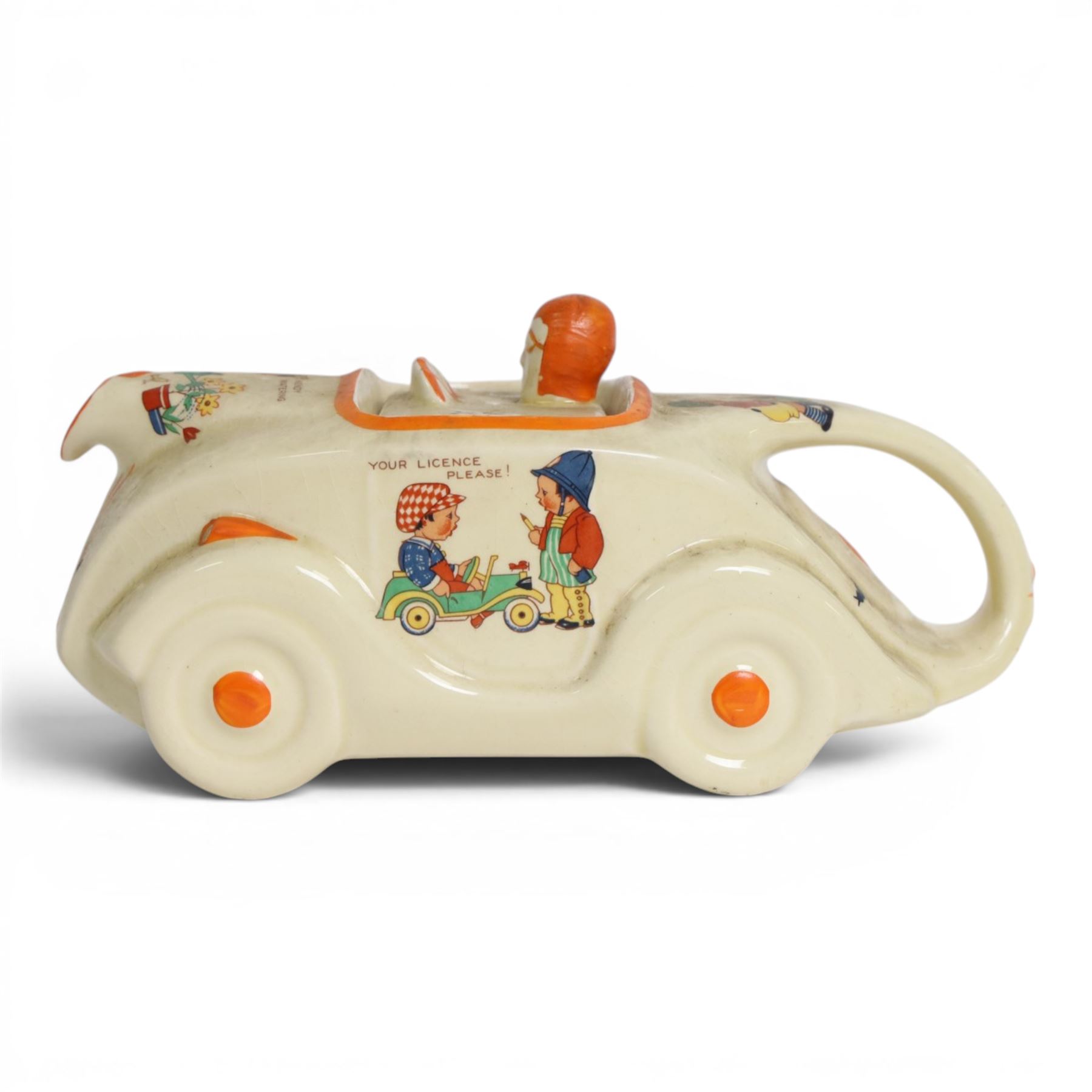 Sadler Art Deco teapot, modelled as a racing car with printed designs in the manner of Mabel Lucie Attwell, H10cm, L23cm